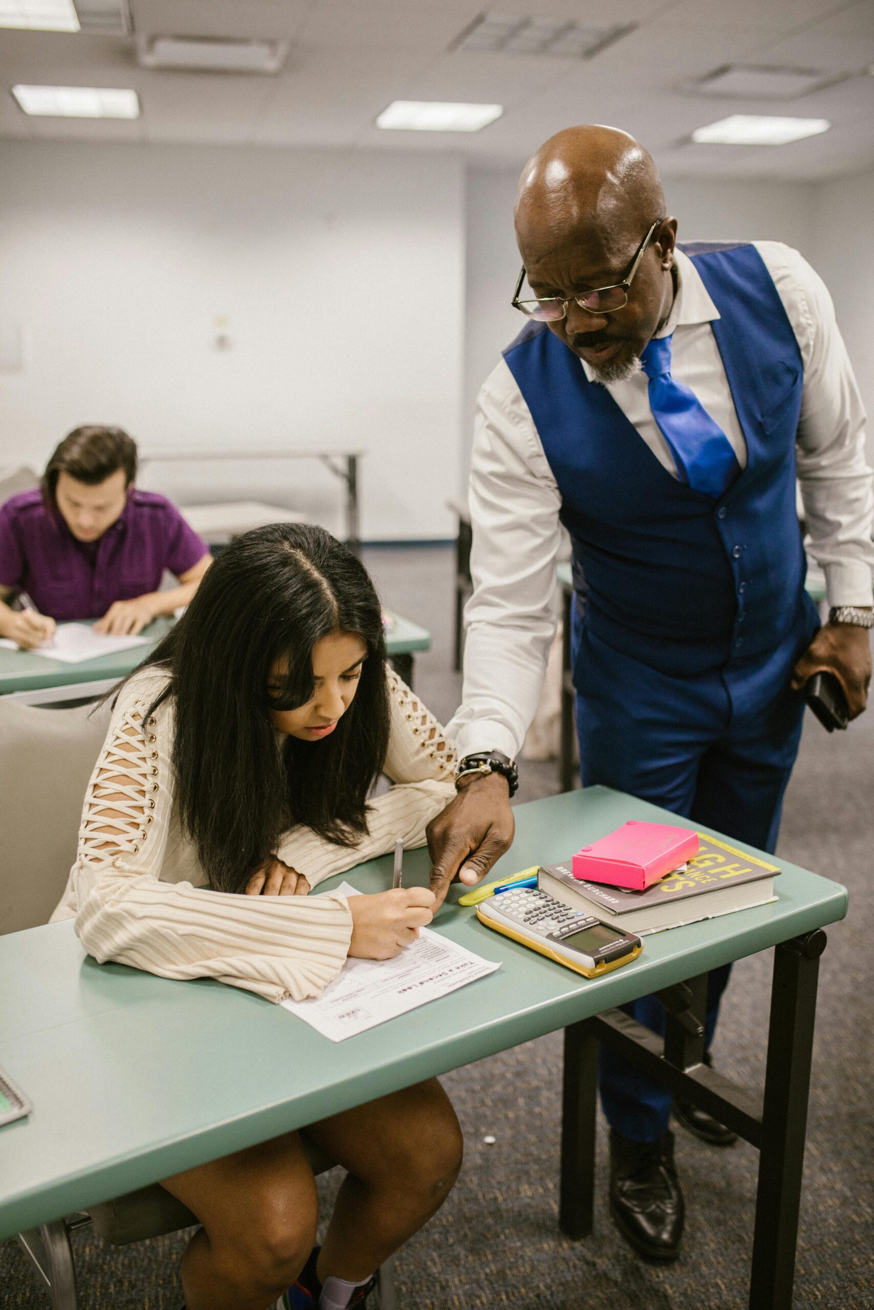 math image with student at desk with black male teacher