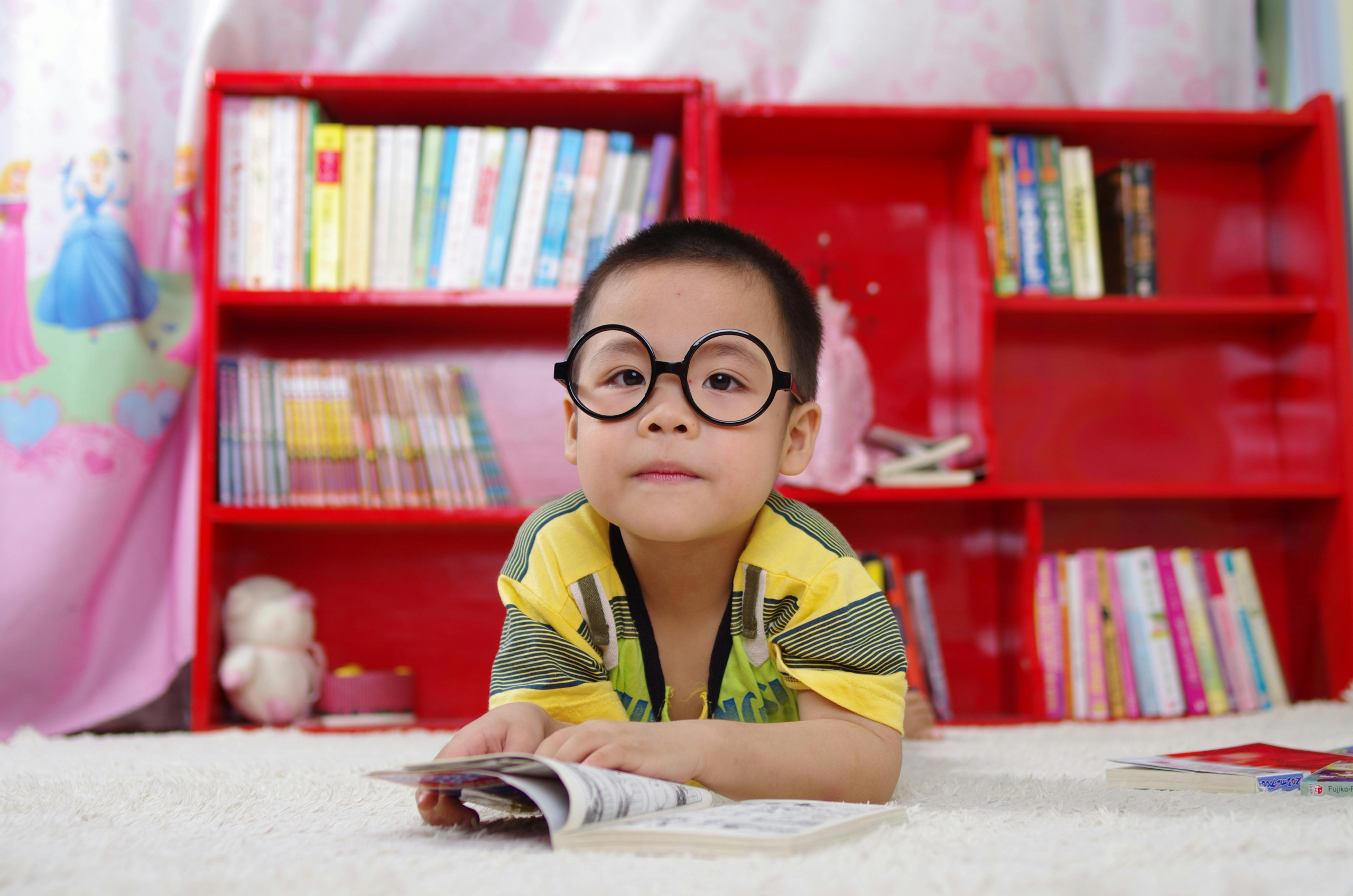 young boy reading a book