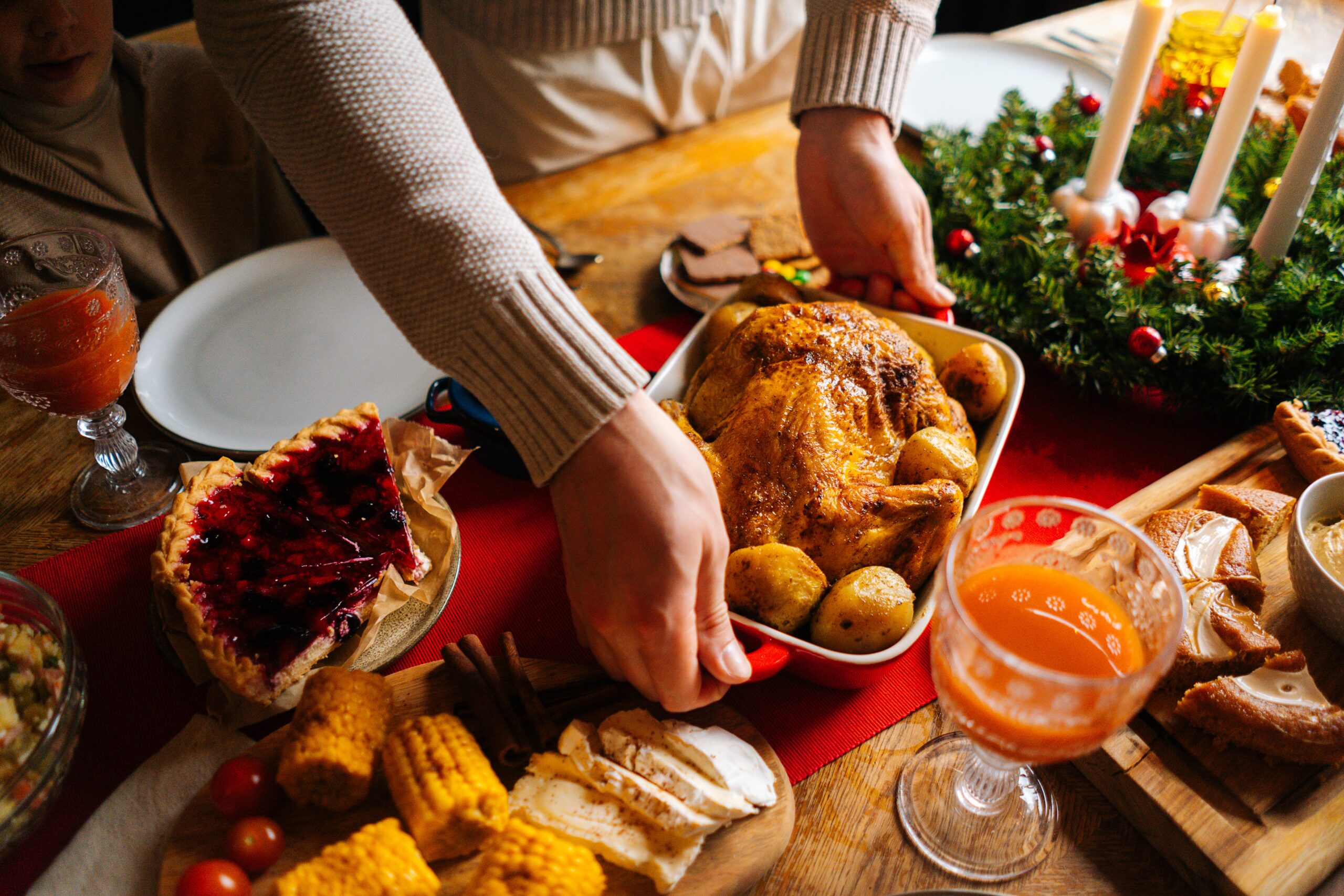 close up,high angle,view,of,young,man,putting,dish,with,roasted